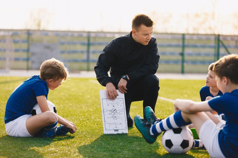 Soccer coach reviewing paperwork